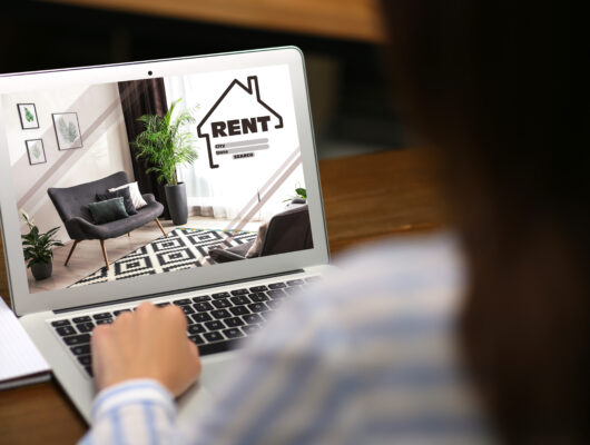 Woman searching properties using her laptop